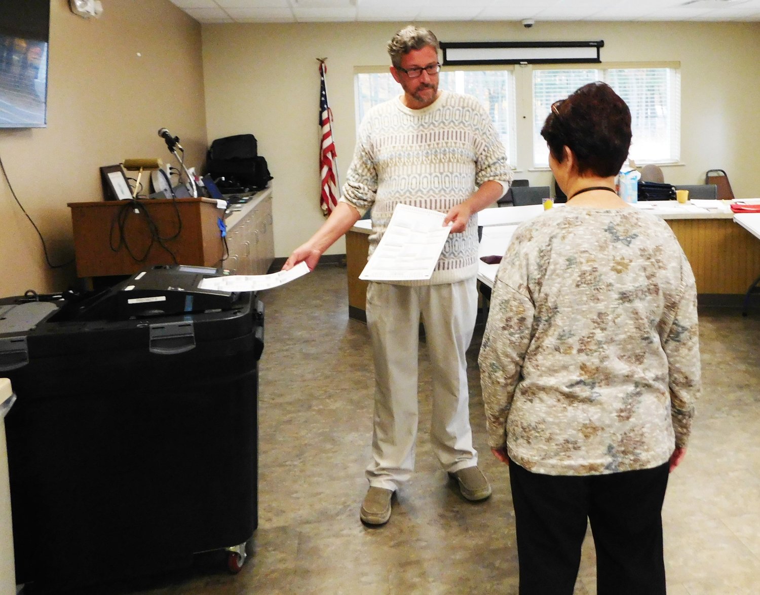 Rick Jones, Hayes Township supervisor, and Maye Tessner-Rood, Hayes treasurer, test out one of the voting tabluators.